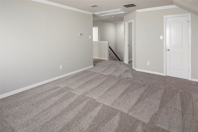 carpeted empty room featuring crown molding