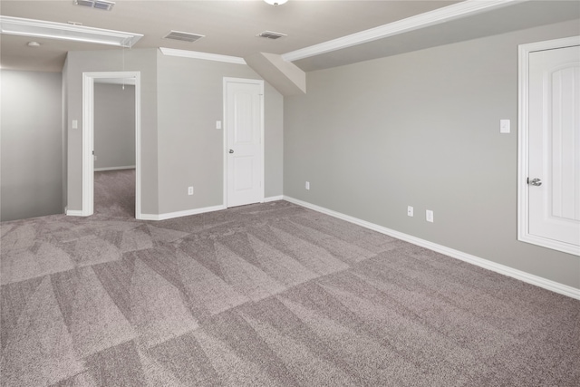 spare room featuring ornamental molding and carpet