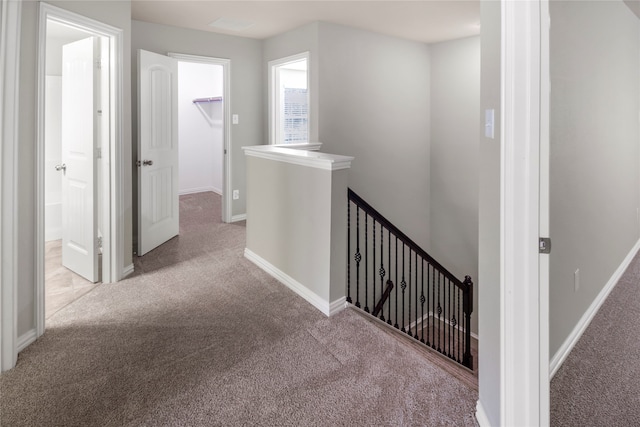 hallway with light colored carpet