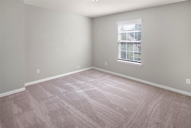 unfurnished room with light carpet