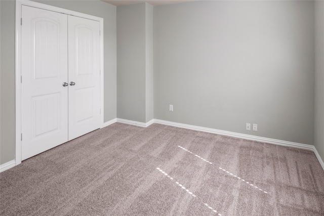 unfurnished bedroom featuring a closet and carpet