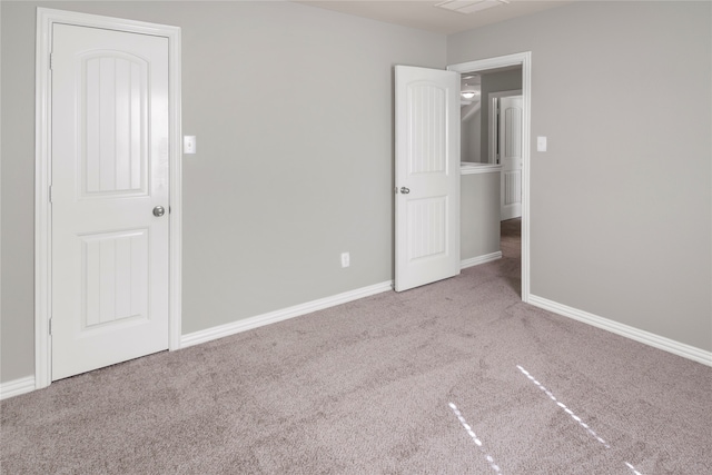 unfurnished bedroom featuring light colored carpet