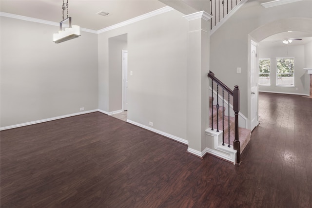 interior space featuring crown molding, ceiling fan, ornate columns, and dark hardwood / wood-style flooring