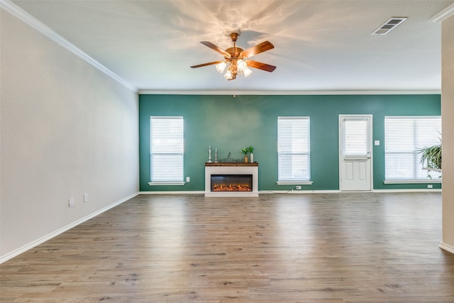 unfurnished living room with ornamental molding, light wood-type flooring, and ceiling fan