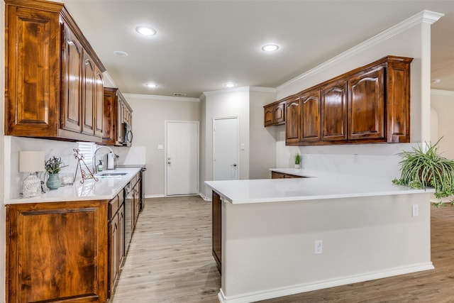 kitchen with light hardwood / wood-style floors, kitchen peninsula, sink, and crown molding