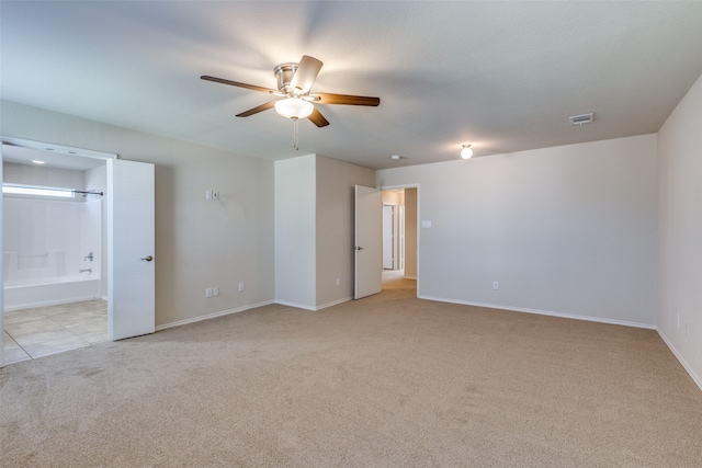 unfurnished room featuring light colored carpet and ceiling fan