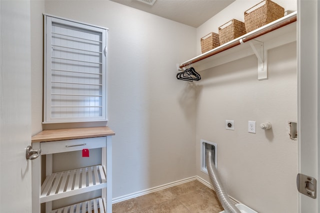 washroom with gas dryer hookup, light tile patterned floors, and electric dryer hookup