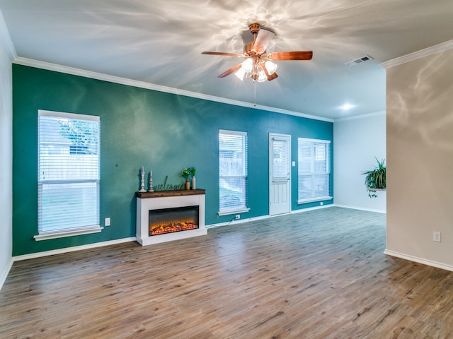 unfurnished living room with hardwood / wood-style floors, crown molding, and ceiling fan