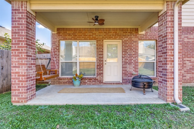 entrance to property featuring a patio and ceiling fan