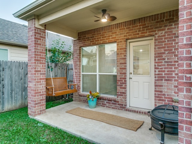 view of exterior entry featuring a patio area and ceiling fan