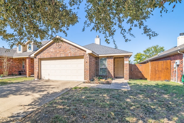 view of front of home featuring a front lawn and a garage