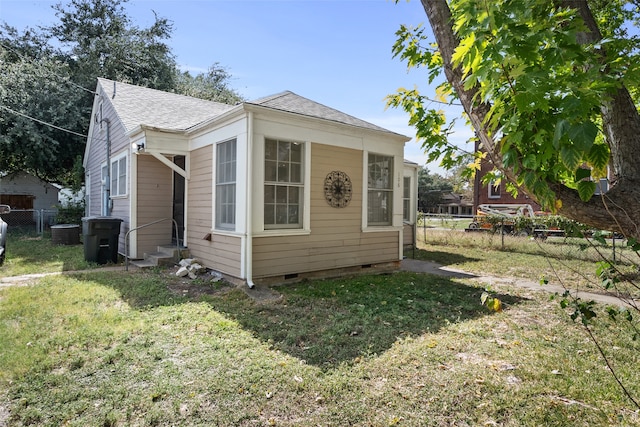 view of side of home featuring a lawn