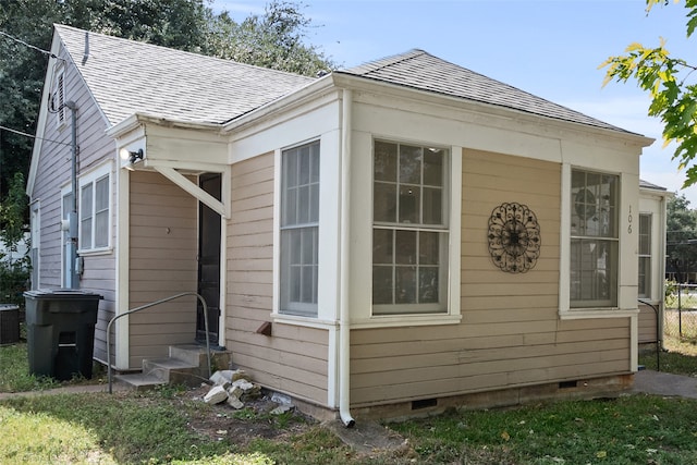 view of side of property with central AC unit