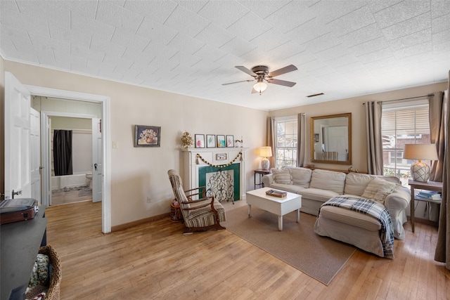 living room featuring light hardwood / wood-style floors and ceiling fan