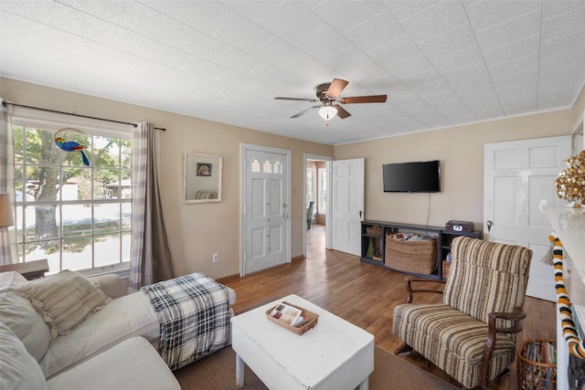 living room featuring ceiling fan, crown molding, and dark hardwood / wood-style flooring