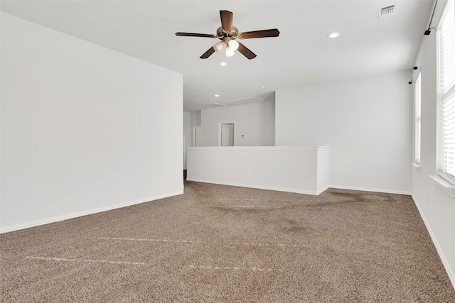 spare room featuring ceiling fan and carpet flooring