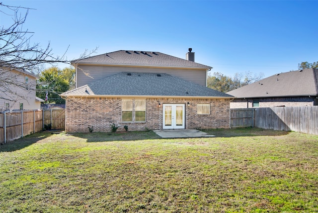 back of house with french doors, a yard, and a patio