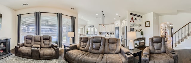 living room with sink, wood-type flooring, and lofted ceiling