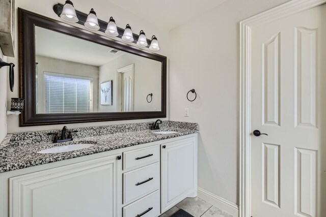 bathroom featuring vanity and tile patterned flooring