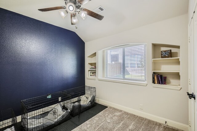 interior space featuring lofted ceiling, carpet floors, and ceiling fan