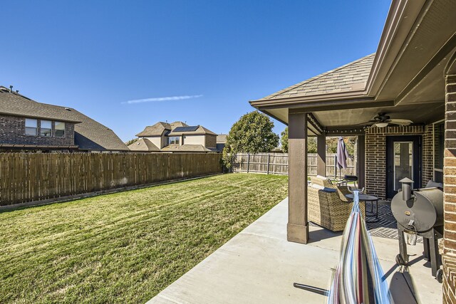 view of yard featuring a patio area and ceiling fan