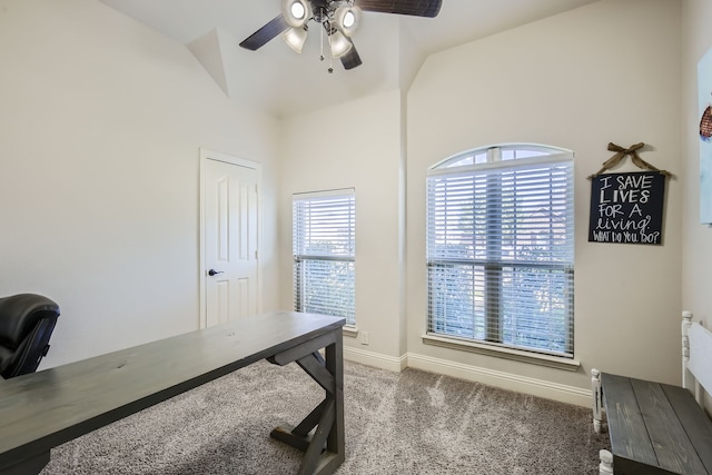 carpeted office space featuring lofted ceiling and ceiling fan