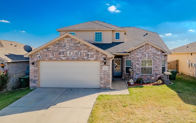 view of front of house with a front yard and a garage