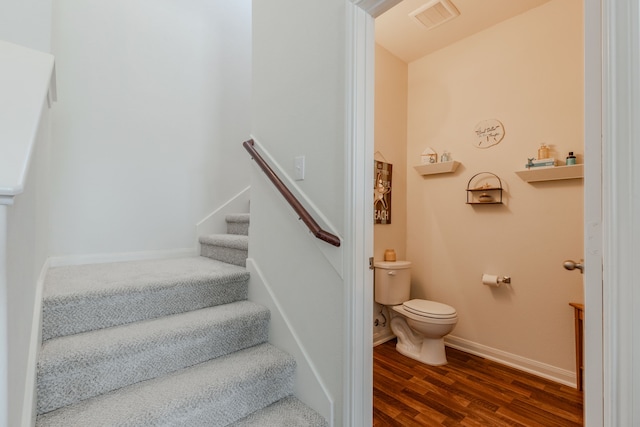 staircase with wood-type flooring