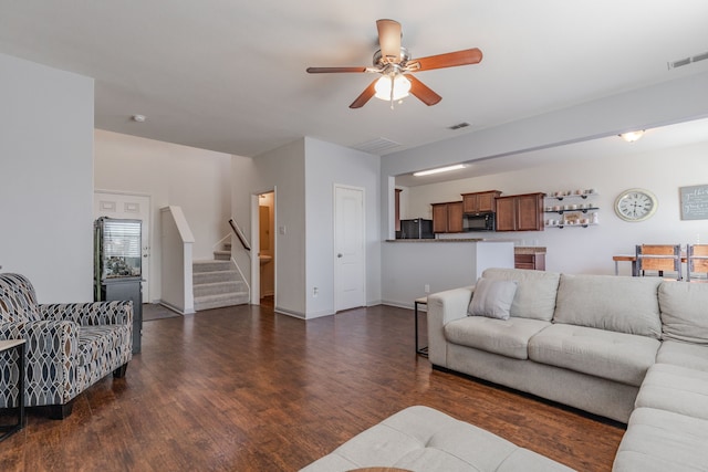 living room with ceiling fan and dark hardwood / wood-style floors