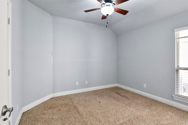 carpeted empty room with ceiling fan and vaulted ceiling