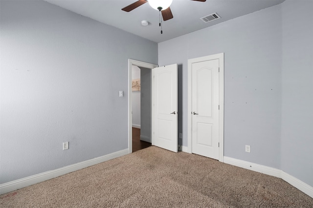 unfurnished bedroom featuring ceiling fan and carpet