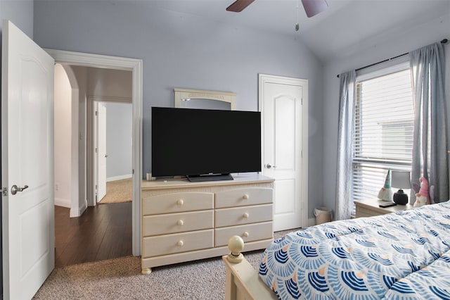 bedroom featuring ceiling fan, dark wood-type flooring, and vaulted ceiling