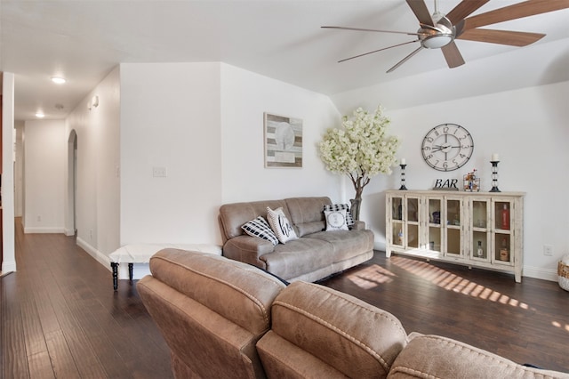 living room with dark wood-type flooring and ceiling fan