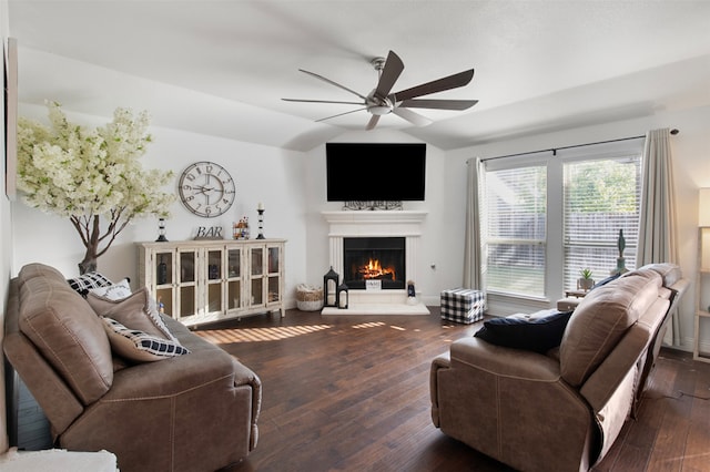 living room with dark wood-type flooring, vaulted ceiling, and ceiling fan