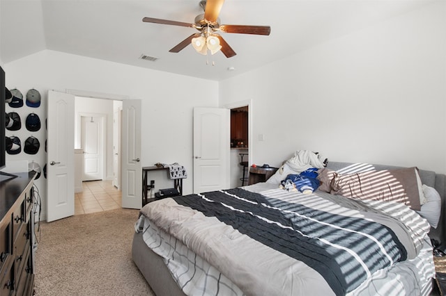 bedroom featuring ceiling fan, light carpet, and vaulted ceiling