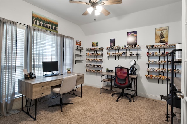 office area featuring lofted ceiling, light carpet, and ceiling fan