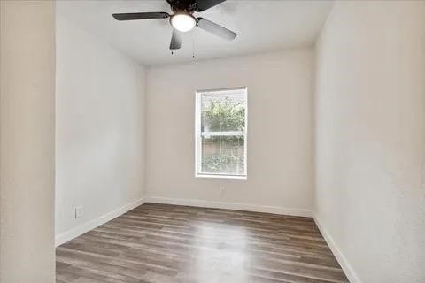 empty room featuring ceiling fan and hardwood / wood-style flooring