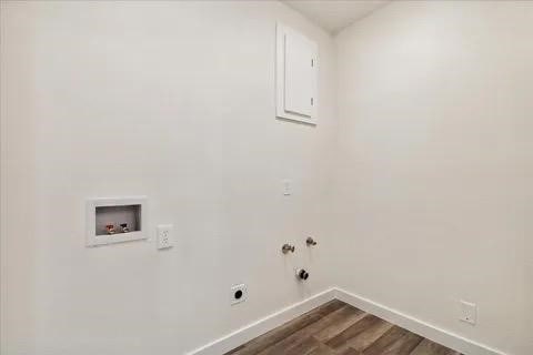 clothes washing area featuring hookup for a gas dryer, hookup for an electric dryer, washer hookup, and hardwood / wood-style flooring