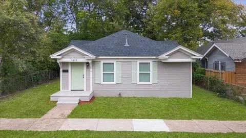 bungalow-style house with a front lawn