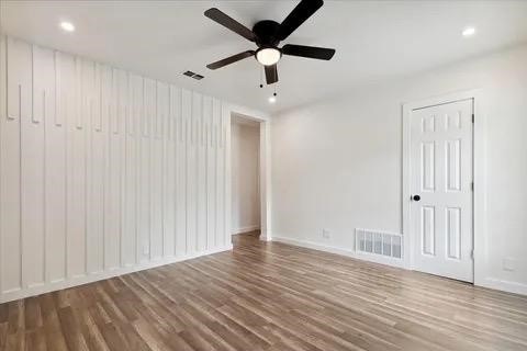 spare room featuring hardwood / wood-style flooring and ceiling fan