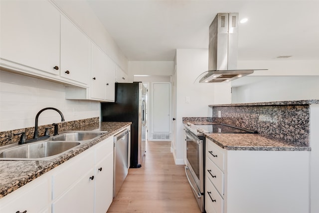 kitchen featuring sink, light wood-type flooring, island range hood, white cabinetry, and stainless steel appliances