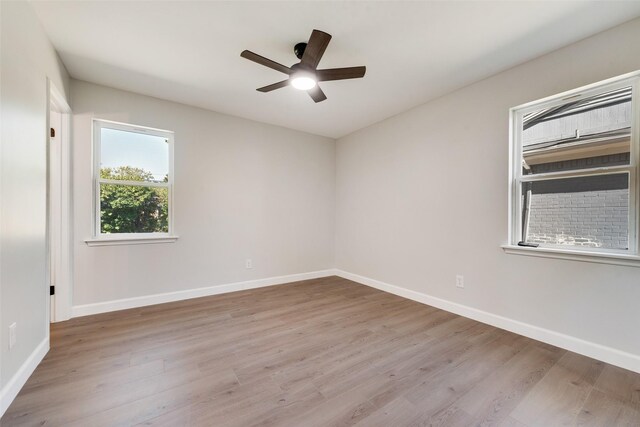 empty room featuring light wood-style flooring and baseboards