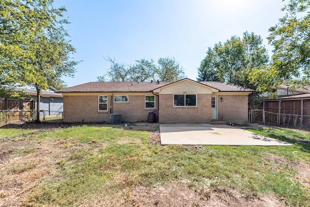 back of property featuring a fenced backyard, a patio, and a lawn