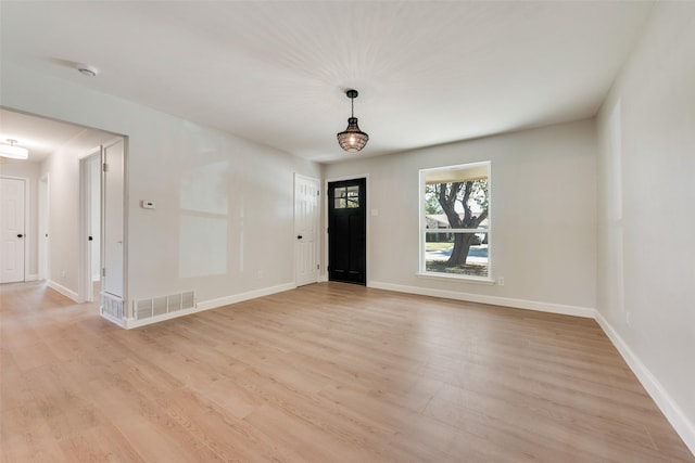 entrance foyer featuring light wood-style flooring, visible vents, and baseboards