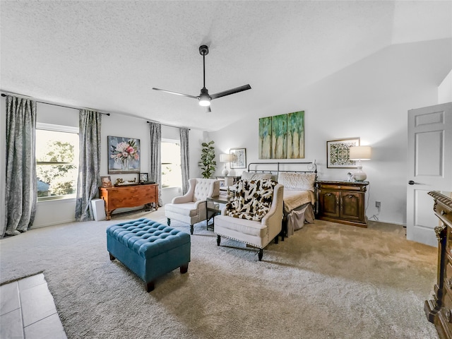 bedroom featuring light carpet, lofted ceiling, multiple windows, and ceiling fan