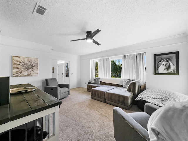 carpeted bedroom featuring ceiling fan, crown molding, and a textured ceiling