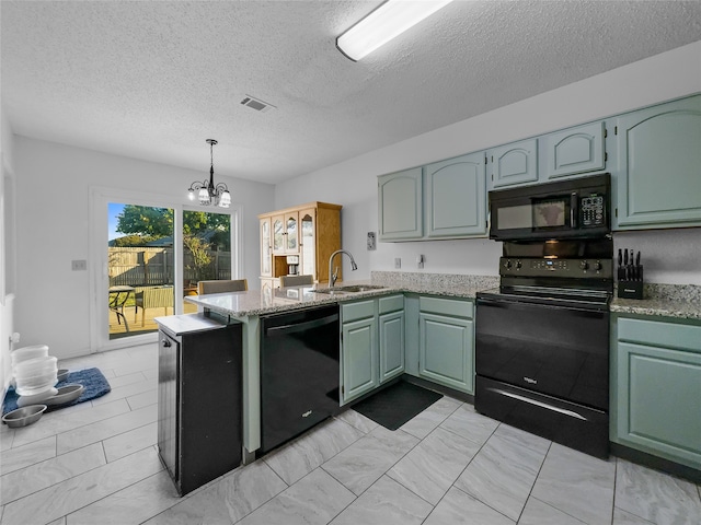 kitchen with sink, black appliances, kitchen peninsula, and a textured ceiling