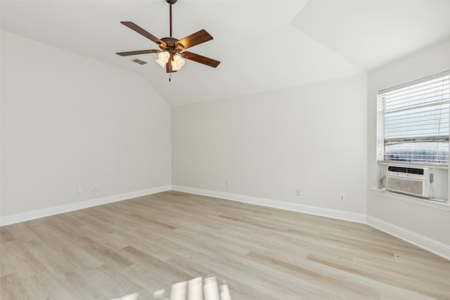 unfurnished room featuring light hardwood / wood-style floors, vaulted ceiling, cooling unit, and ceiling fan