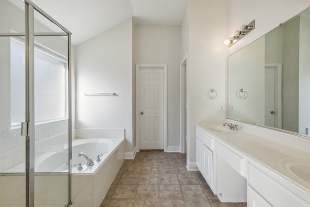 bathroom featuring tile patterned floors, vanity, separate shower and tub, and lofted ceiling