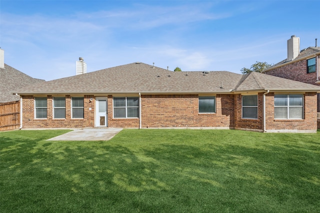 back of property featuring a yard and a patio